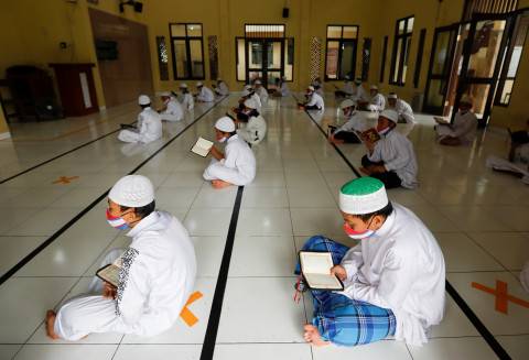 Para santri mengaji dengan menggunakan masker dan menerapkan jarak fisik di Pondok Pesantren Daarul Qur'an Al Kautsar, Bogor. (Foto: REUTERS/Willy Kurniawan)