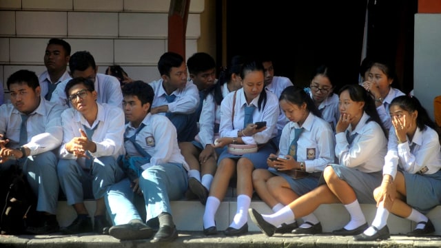 Sejumlah siswa menyimak pengarahan ditundanya pelaksanaan Ujian Nasional Berbasis Komputer (UNBK) di SMK Pariwisata Dalung, Badung, Bali, Senin (16/3/2020). (Foto: Fikri Yusuf/Kumparan.com)