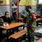 Petugas Gabungan TNI-Polri Razia Masker di Warung Kopi di Surabaya
